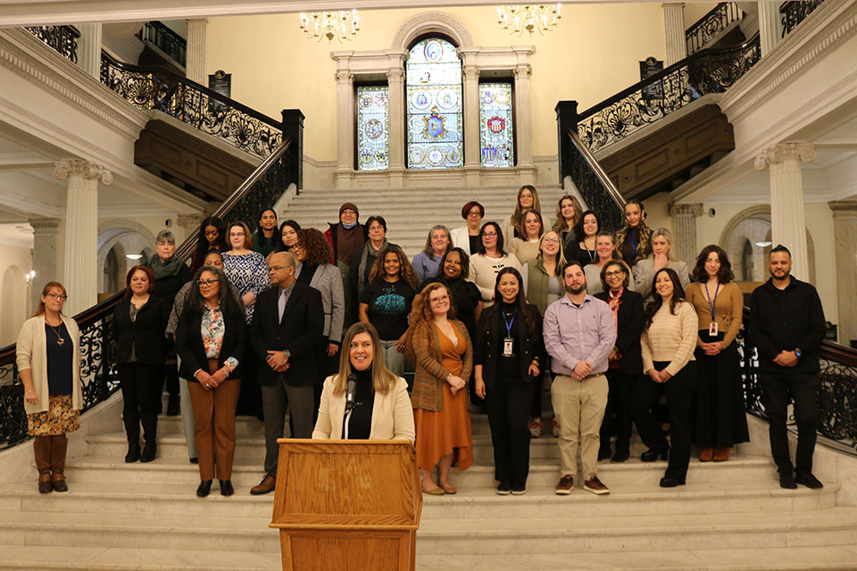 Massachusetts Health Connector Executive Director Audrey Morse Gasteier speaks about the end of Open Enrollment on Jan. 23, and the availability of enrollment help from local Navigator organizations, at the Grand Staircase in the Massachusetts State House on Jan. 13. Morse Gasteier was joined by more than 30 representatives from 15 Navigator organizations at the event.