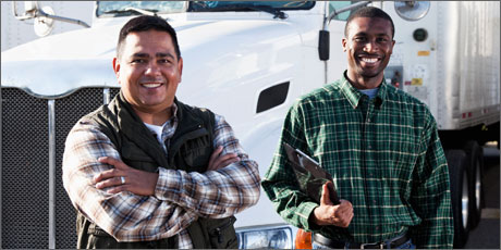 Two smiling male employees with a shipping company